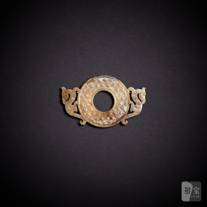 A white jade 'dragon' disc, huan, Eastern Zhou dynasty, Warring States period | 東周戰國 白玉雙龍紋出廓谷紋環